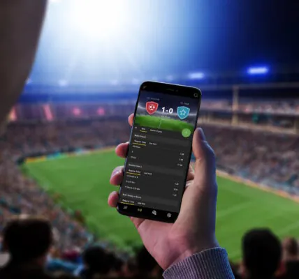 a man is betting on his cell phone